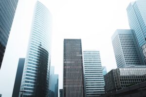 A collage of different commercial building types including office, retail, and hospital buildings.
