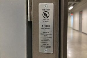 Fire-rated door with visible certification label and overhead door closer
