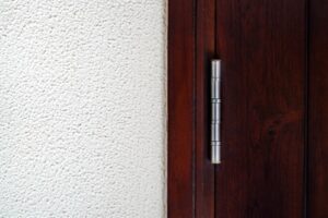 Fire door hardware components including hinges, closer, and push bar