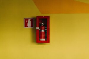 fire extinguishers mounted on a wall in a commercial building.