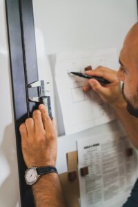 Inspector checking a fire door's certification label and condition