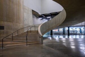Elegant lobby with curved staircase and modern lighting