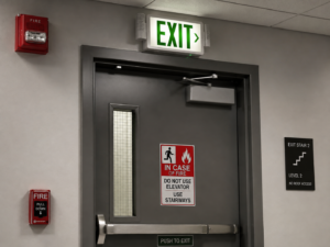 Illuminated exit sign above a commercial door