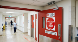 Exit door swinging outward with push bar hardware
