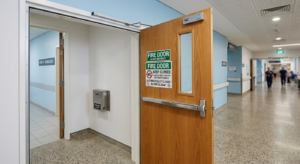 Fire door with automatic hold-open device and clear signage