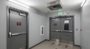 Pressurized smoke-stop lobby with fire-rated doors