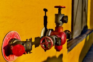 Firestop material being applied around pipes in a commercial building