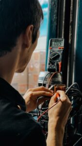 Technician testing a smoke detector with a test aerosol