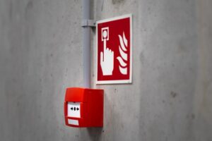 Manual pull station on a commercial building wall