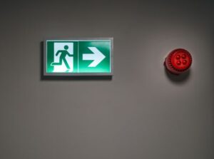 Fire alarm strobe and horn on a commercial building wall