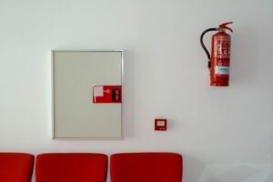 Fire extinguisher and fire alarm pull station in a commercial corridor