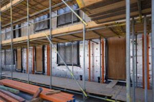Air barrier being installed on a commercial building exterior