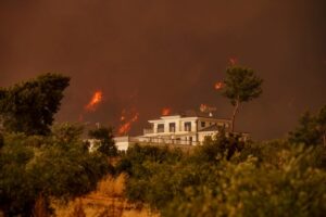 Conceptual illustration of wildfire embers landing on a commercial building roof.