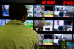 Security control room with multiple monitors displaying CCTV feeds